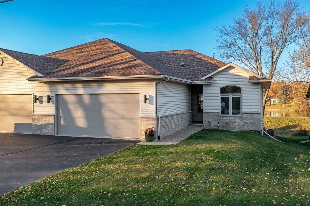 5624 Spring Brook Road, Unit 5624 Rockford, IL 61114 - Photo 2 of 34 a front view of a house with a yard