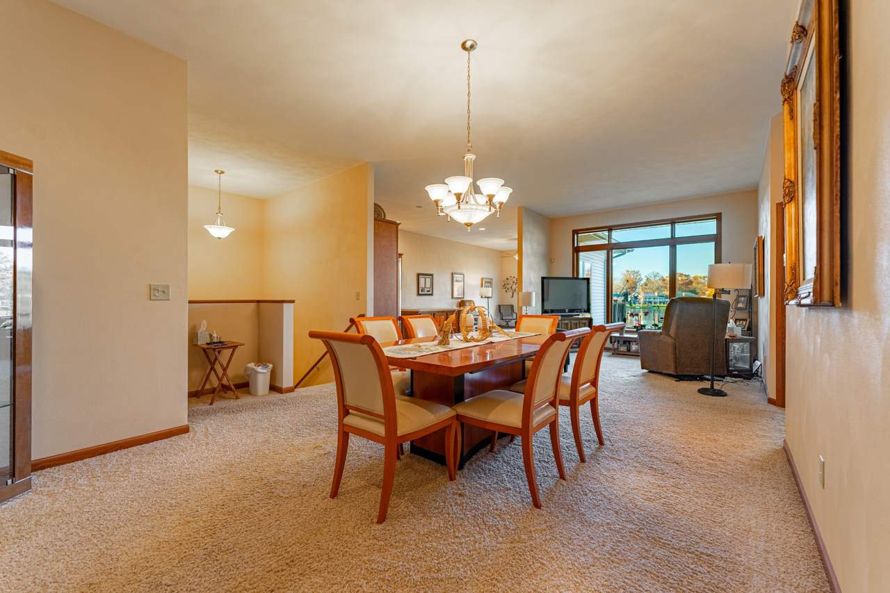 5624 Spring Brook Road, Unit 5624 Rockford, IL 61114 - Photo 5 of 34 a view of a dining room with furniture and a chandelier