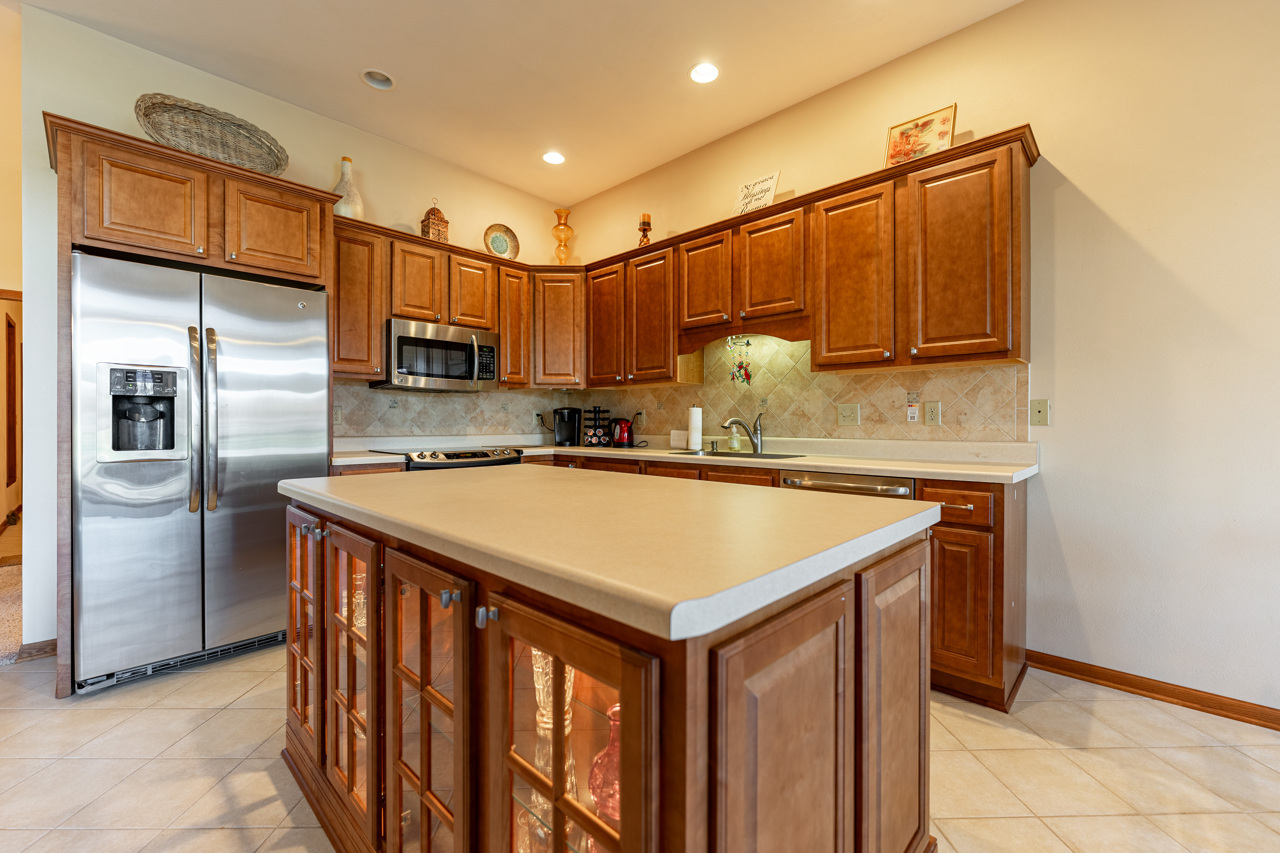 5624 Spring Brook Road, Unit 5624 Rockford, IL 61114 - Photo 10 of 34 a kitchen with stainless steel appliances granite countertop a sink a refrigerator and a microwave