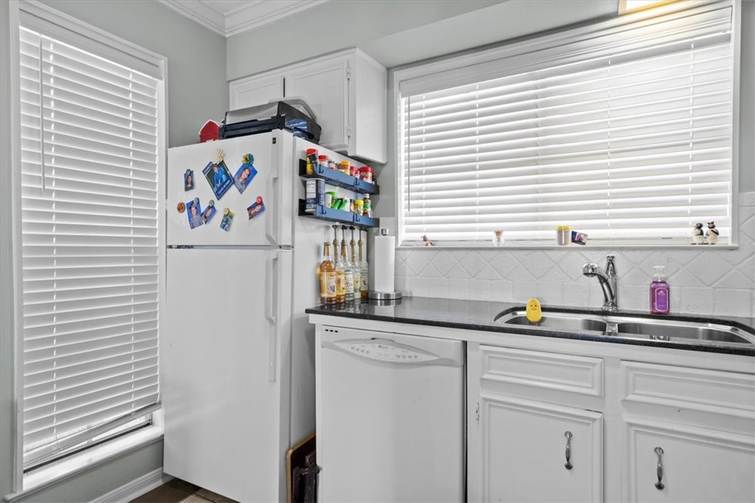 2903 Lake Shore Drive, Unit 303 Waco, TX 76708 - Photo 11 of 29 a kitchen with a refrigerator and a sink