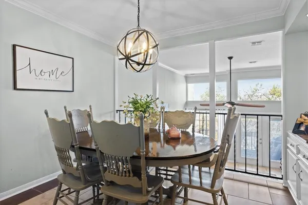 a dining room with furniture and wooden floor