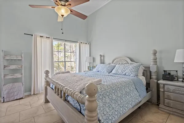 a bedroom with a bed and a chandelier