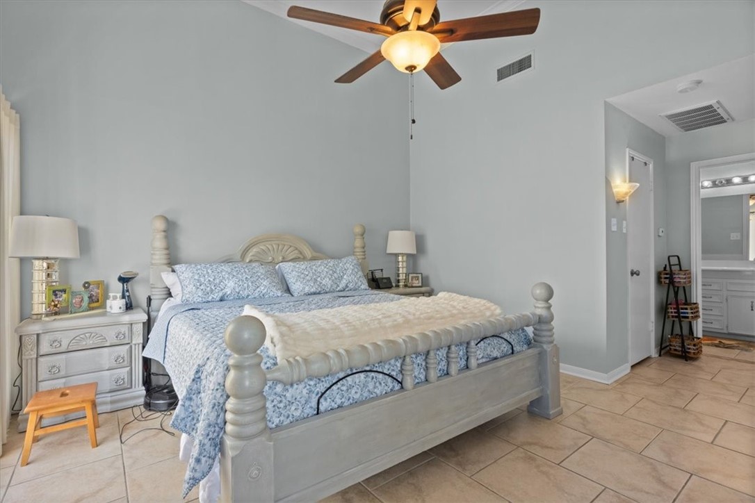 2903 Lake Shore Drive, Unit 303 Waco, TX 76708 - Photo 15 of 29 a bedroom with a bed and a chandelier