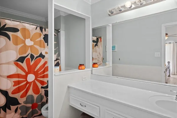 a bathroom with a sink vanity and tub