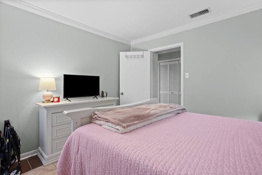 2903 Lake Shore Drive, Unit 303 Waco, TX 76708 - Photo 21 of 29 a bedroom with a bed and a flat screen tv