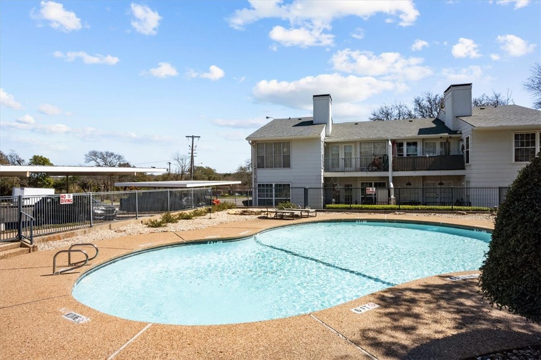 2903 Lake Shore Drive, Unit 303 Waco, TX 76708 - Photo 27 of 29 a view of a swimming pool with a table and chairs