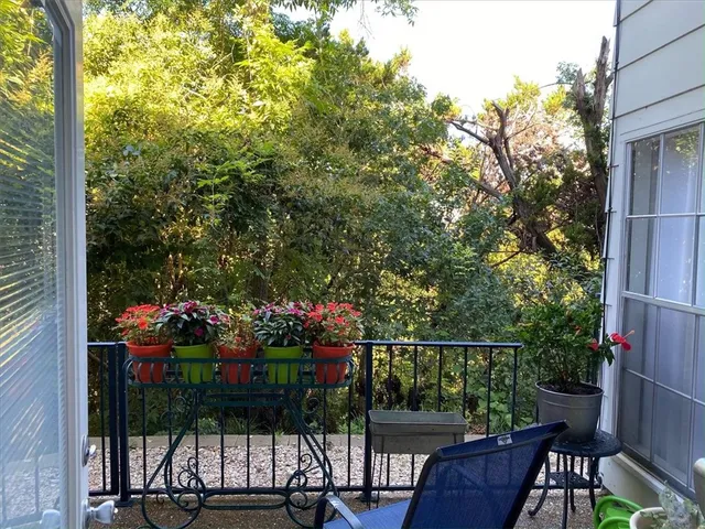 a view of a chairs and table in the patio with a barbeque