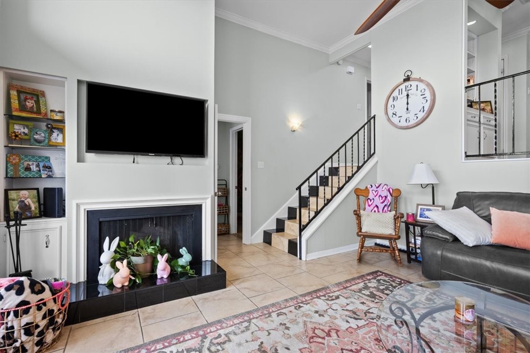 2903 Lake Shore Drive, Unit 303 Waco, TX 76708 - Photo 6 of 29 a living room with furniture a flat screen tv and a fireplace