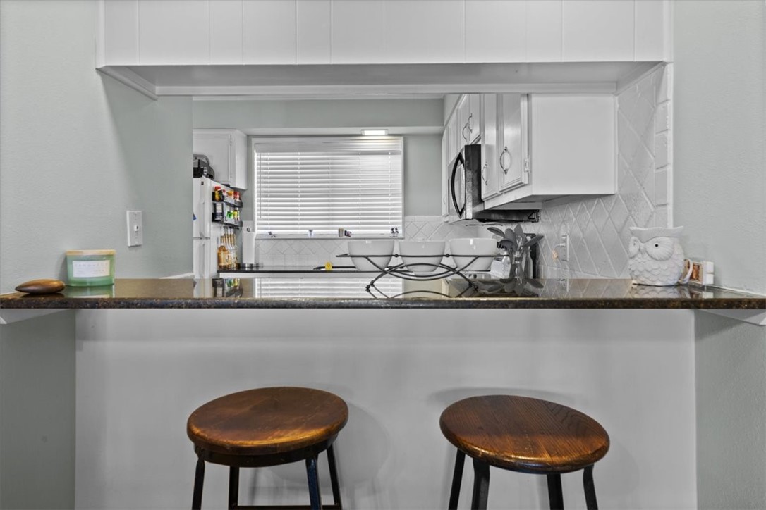 2903 Lake Shore Drive, Unit 303 Waco, TX 76708 - Photo 8 of 29 a kitchen with stainless steel appliances a sink and a chair