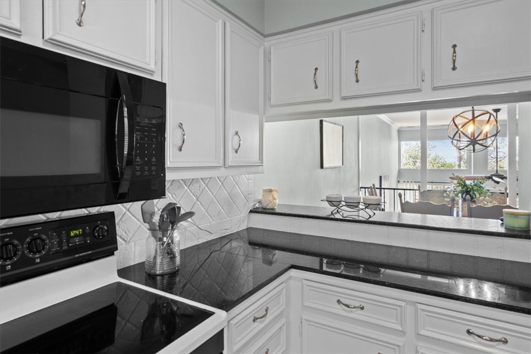 2903 Lake Shore Drive, Unit 303 Waco, TX 76708 - Photo 10 of 29 a kitchen with stainless steel appliances a sink dishwasher a stove and white cabinets