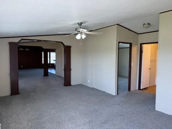 a view of empty room with ceiling fan
