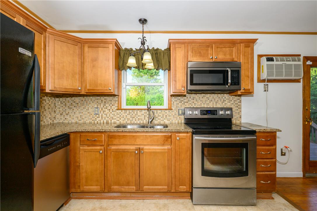 1644 9th Street Bethlehem, PA 18020 - Photo 8 of 27 Well-appointed kitchen featuring wood cabinetry and an array of stainless steel appliances.