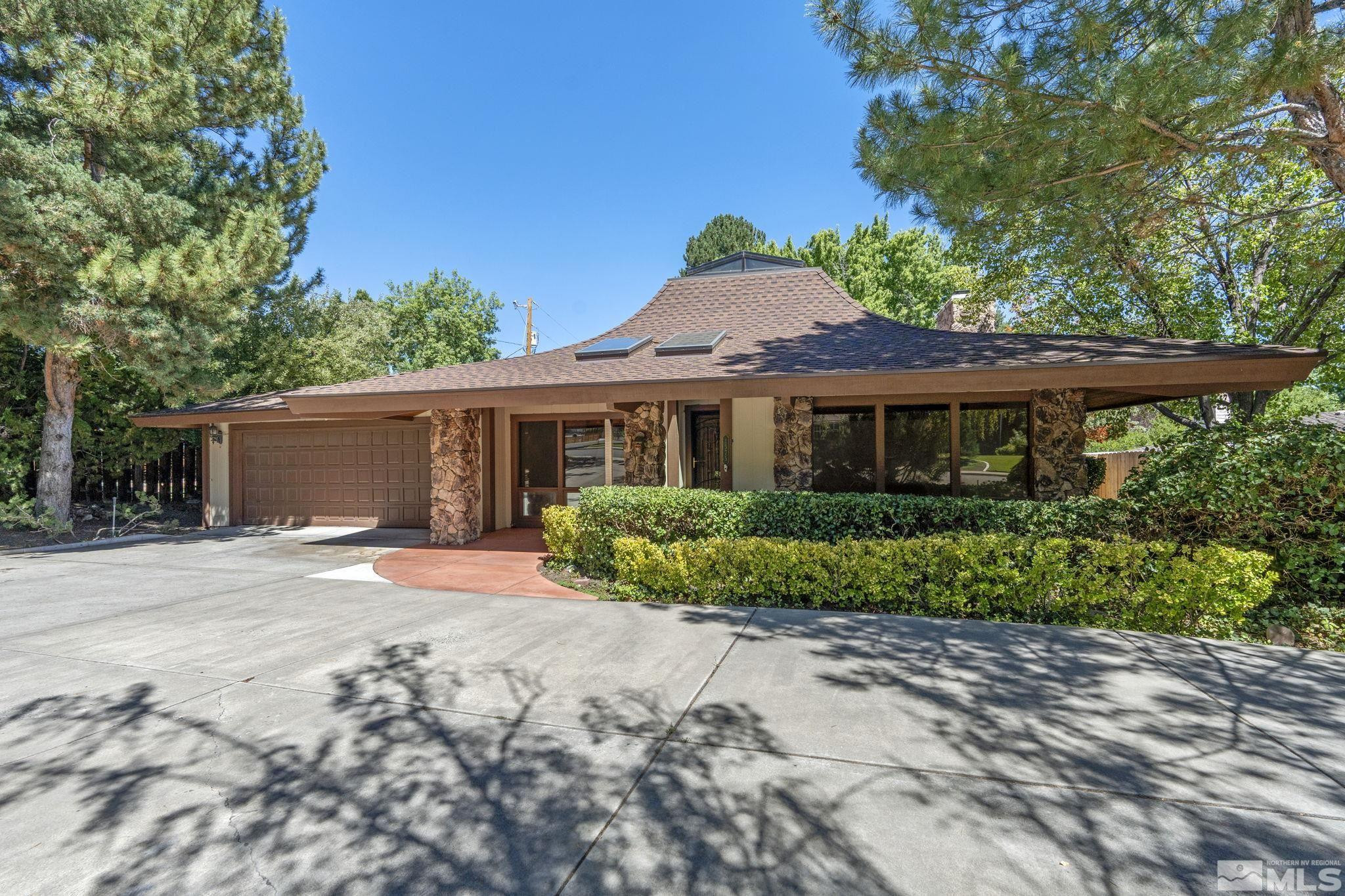a front view of a house with a garden