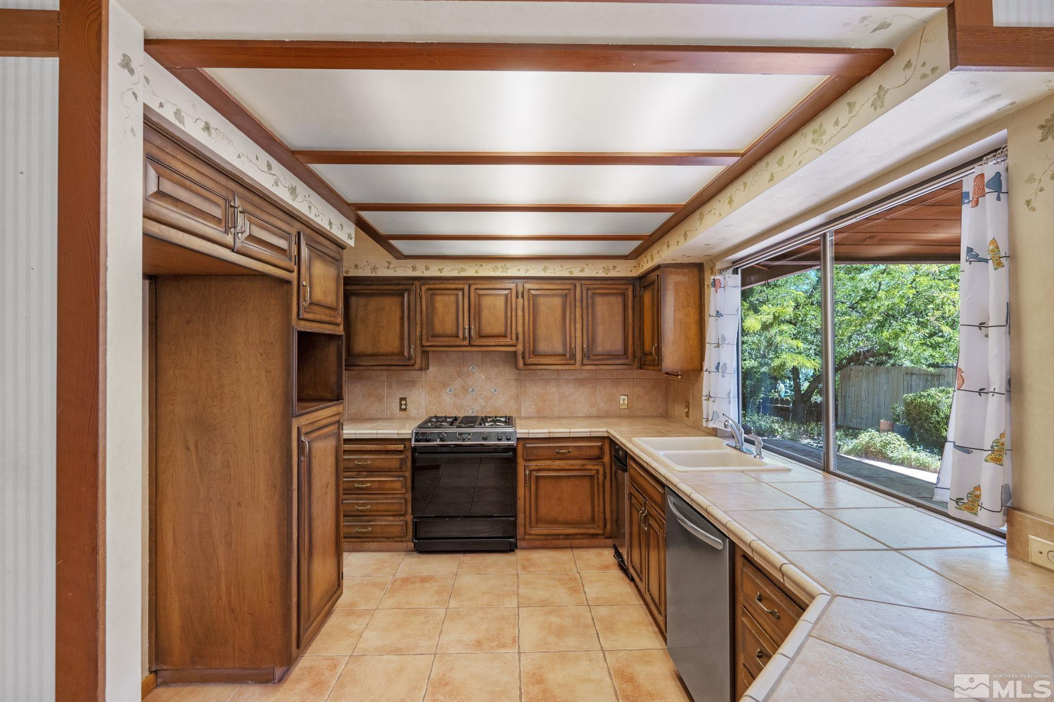 1575 Webster Way Reno, NV 89509 - Photo 14 of 40 a large kitchen with stainless steel appliances granite countertop a sink and large cabinets