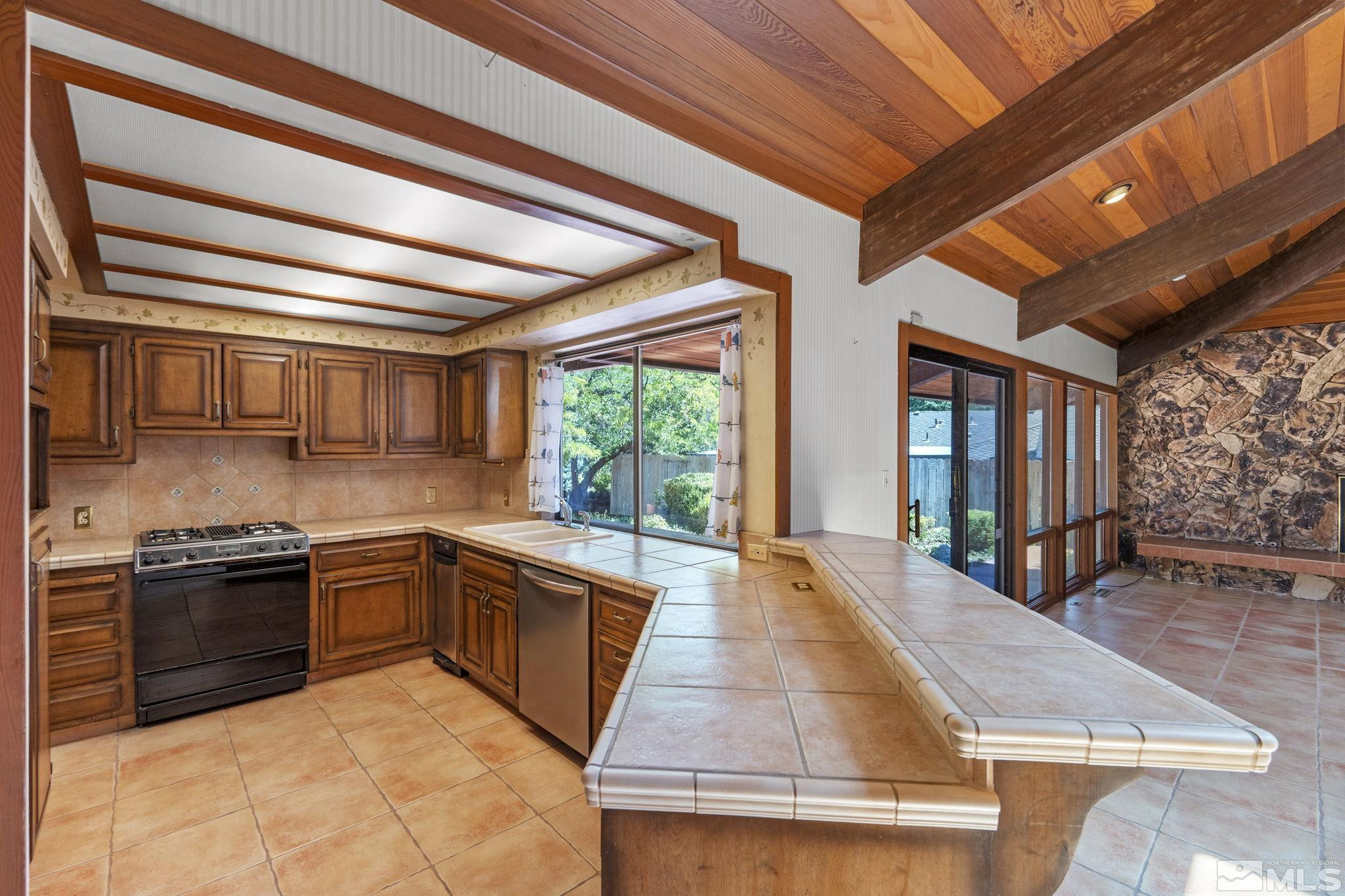 1575 Webster Way Reno, NV 89509 - Photo 16 of 40 a large kitchen with stainless steel appliances granite countertop a stove and a refrigerator