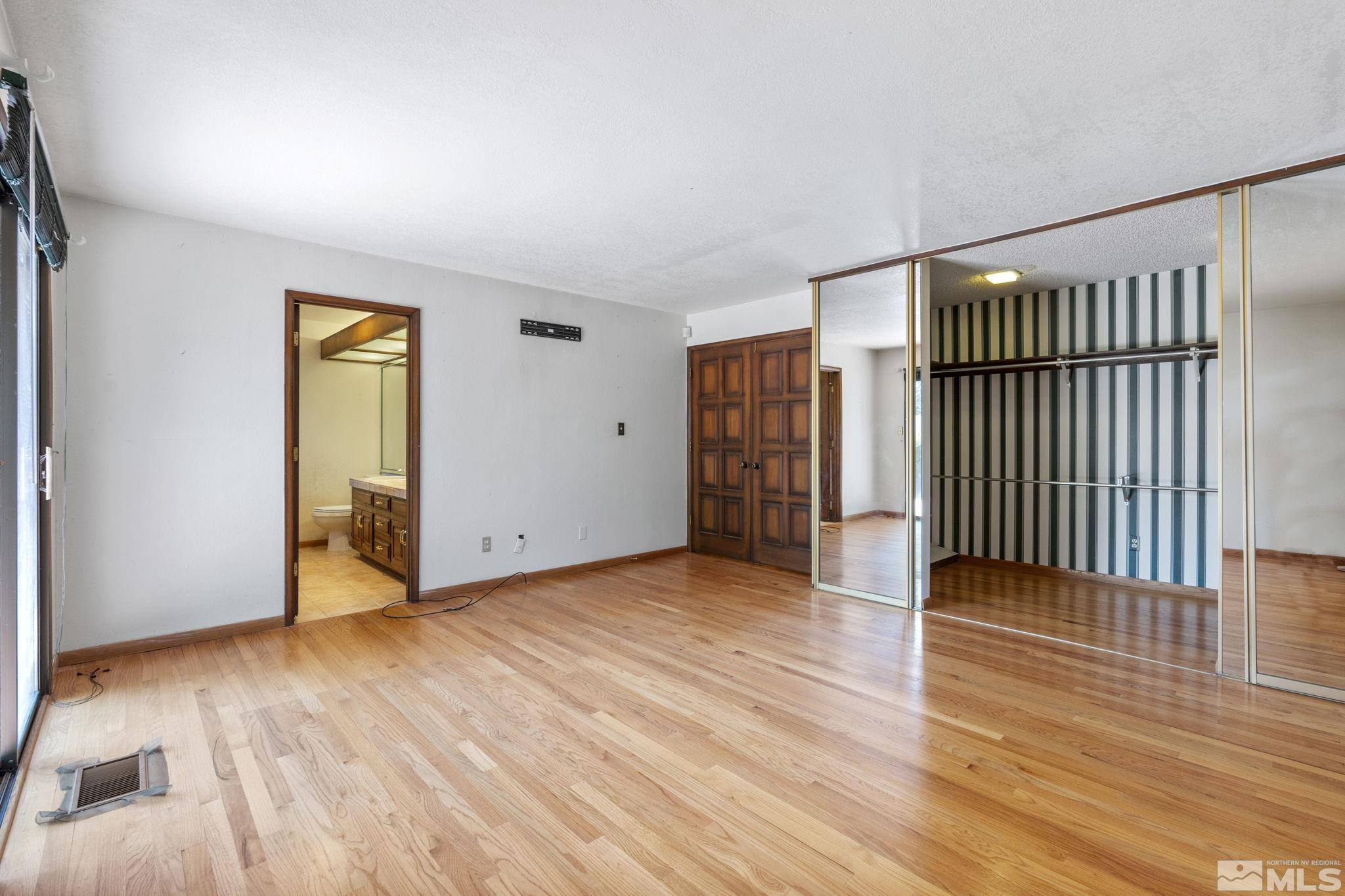 1575 Webster Way Reno, NV 89509 - Photo 23 of 40 an empty room with wooden floor and a ceiling fan