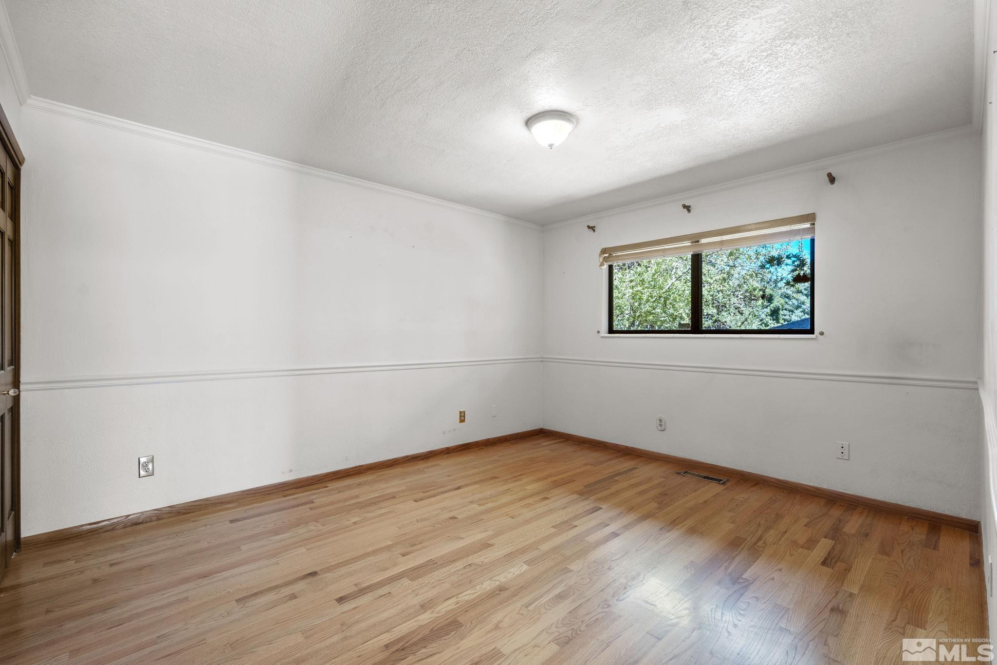 1575 Webster Way Reno, NV 89509 - Photo 27 of 40 an empty room with wooden floor and window
