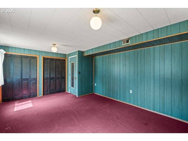 8108 Azalea-Glen Road Glendale, OR 97442 - Photo 28 of 44 a view of an empty room with wooden floor