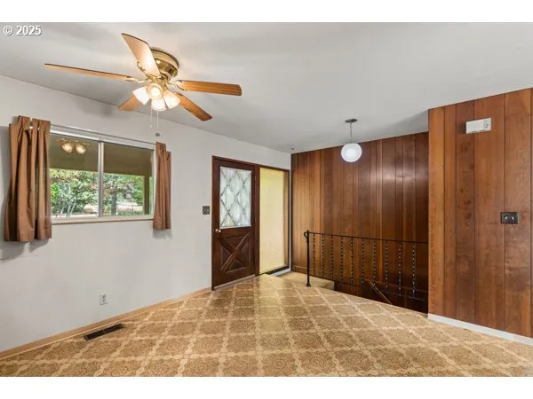 a view of an empty room with window and bathroom