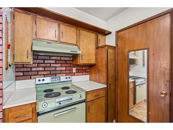 a kitchen with stainless steel appliances granite countertop a stove a refrigerator and a microwave