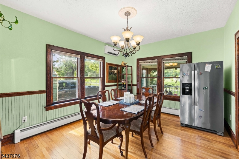 886 Brass Castle Road Belvidere, NJ 07823 - Photo 11 of 44 a view of a dining room with furniture a chandelier and wooden floor