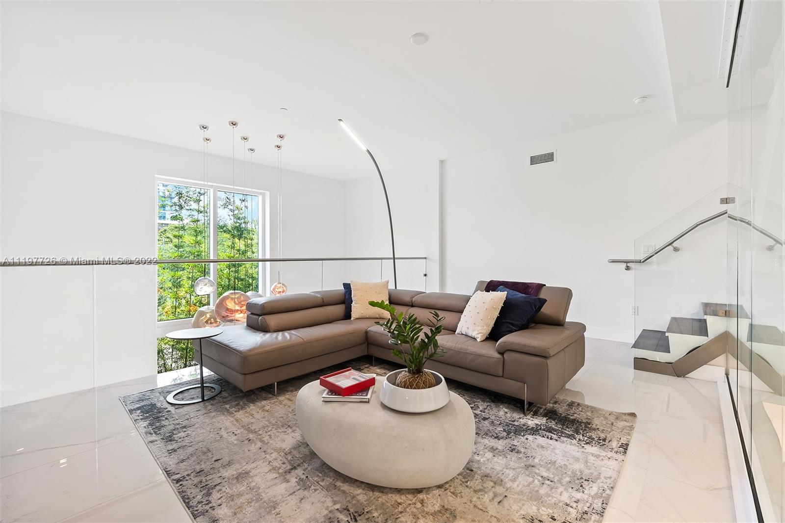 455 Northeast 39th Street, Unit 112 Miami, FL 33137 - Photo 15 of 40 a living room with furniture and a large window