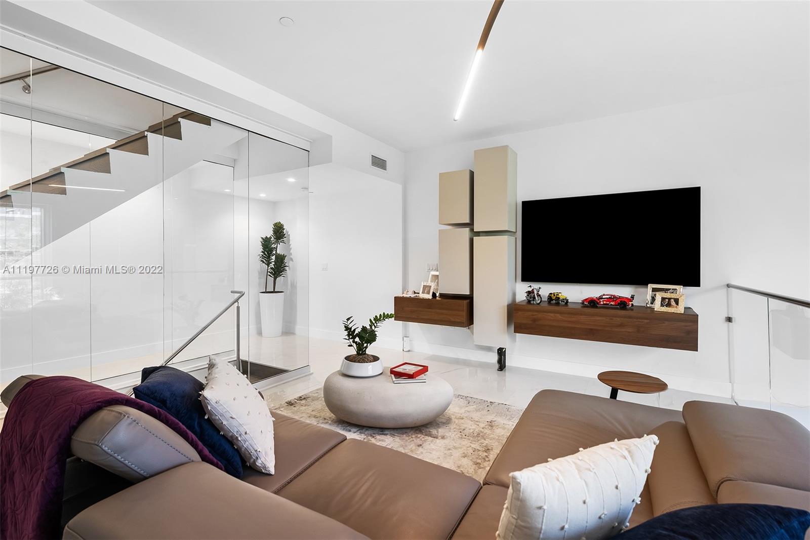 455 Northeast 39th Street, Unit 112 Miami, FL 33137 - Photo 16 of 40 a living room with furniture and a flat screen tv