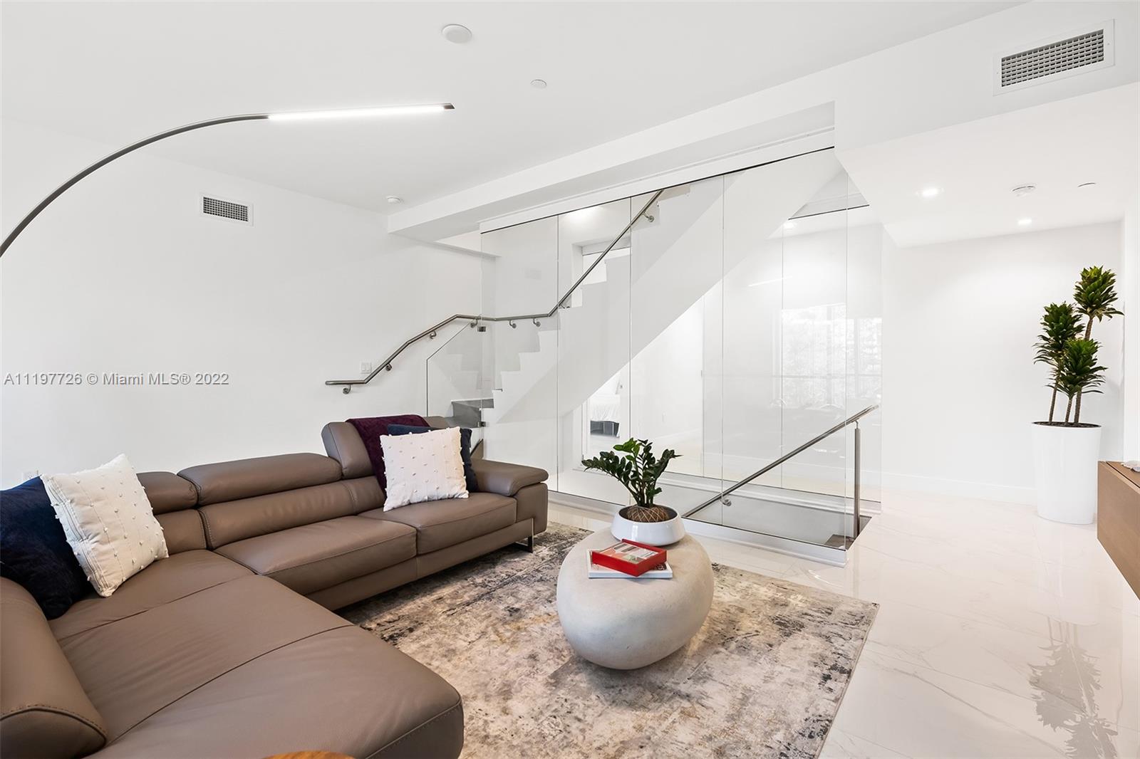 455 Northeast 39th Street, Unit 112 Miami, FL 33137 - Photo 17 of 40 a living room with furniture and a potted plant