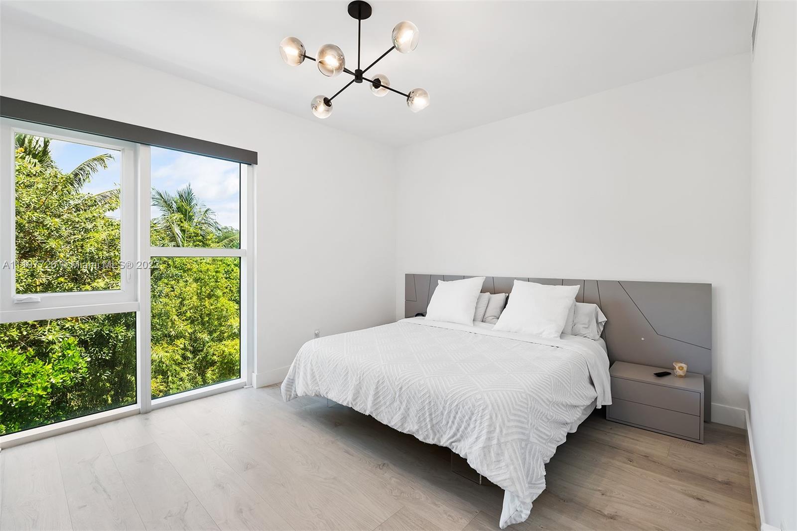 455 Northeast 39th Street, Unit 112 Miami, FL 33137 - Photo 19 of 40 a bedroom with a large bed and a window