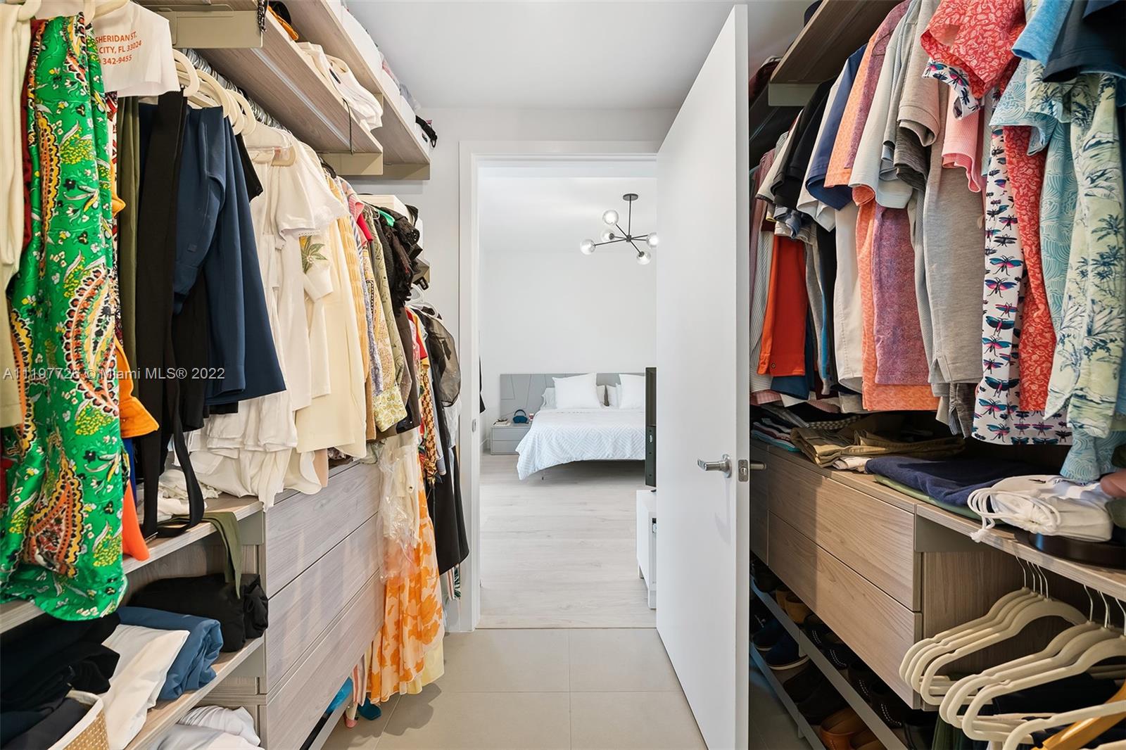 455 Northeast 39th Street, Unit 112 Miami, FL 33137 - Photo 20 of 40 a view of walk in closet with clothes and shoes