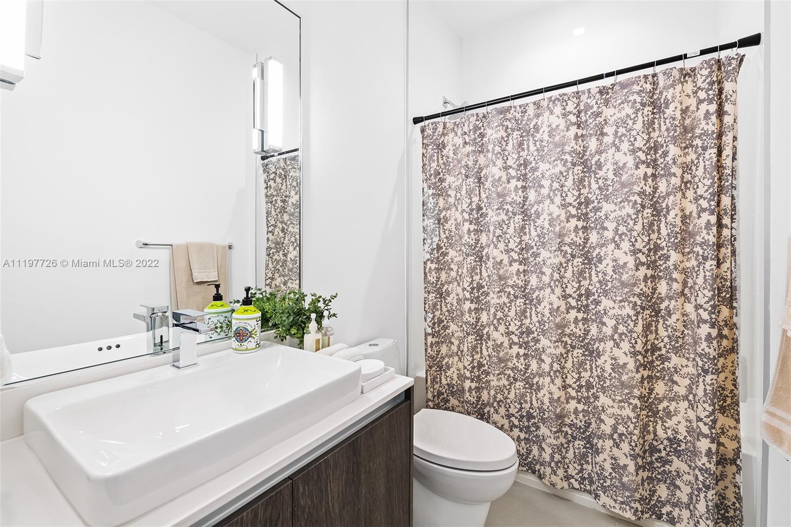 455 Northeast 39th Street, Unit 112 Miami, FL 33137 - Photo 23 of 40 a bathroom with a sink and a mirror