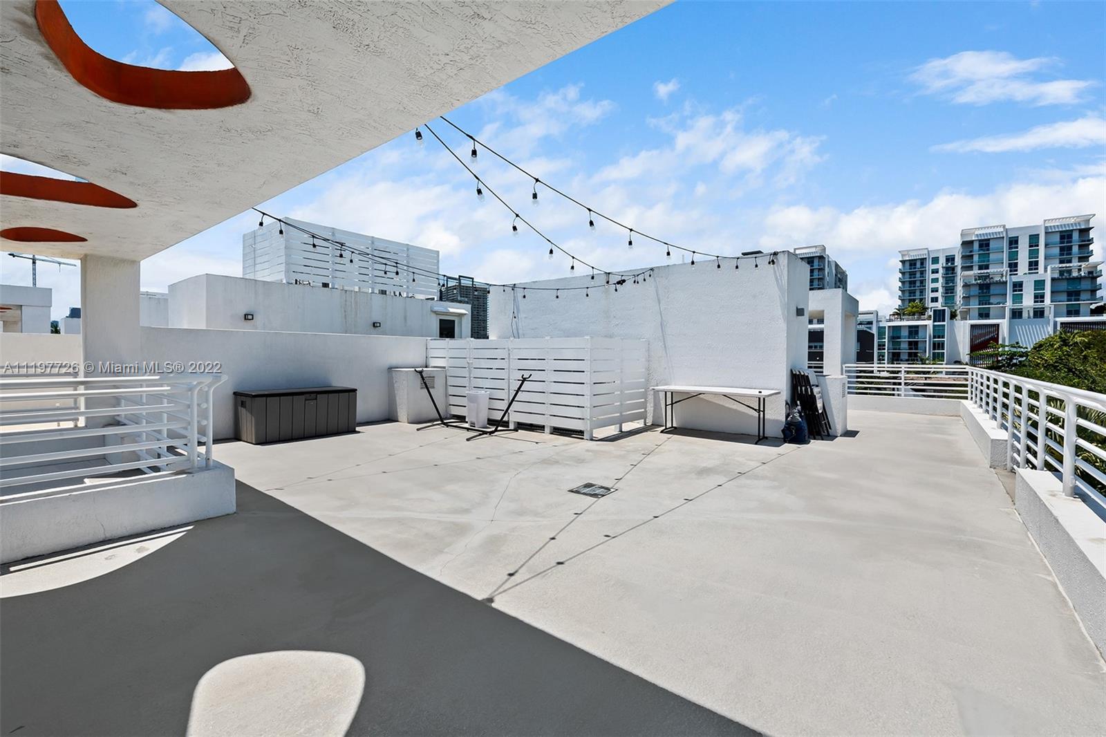 455 Northeast 39th Street, Unit 112 Miami, FL 33137 - Photo 25 of 40 a large kitchen with stainless steel appliances kitchen island granite countertop a sink and cabinets