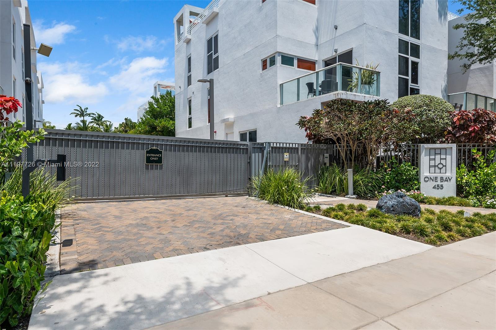 455 Northeast 39th Street, Unit 112 Miami, FL 33137 - Photo 40 of 40 a view of a white house next to a yard