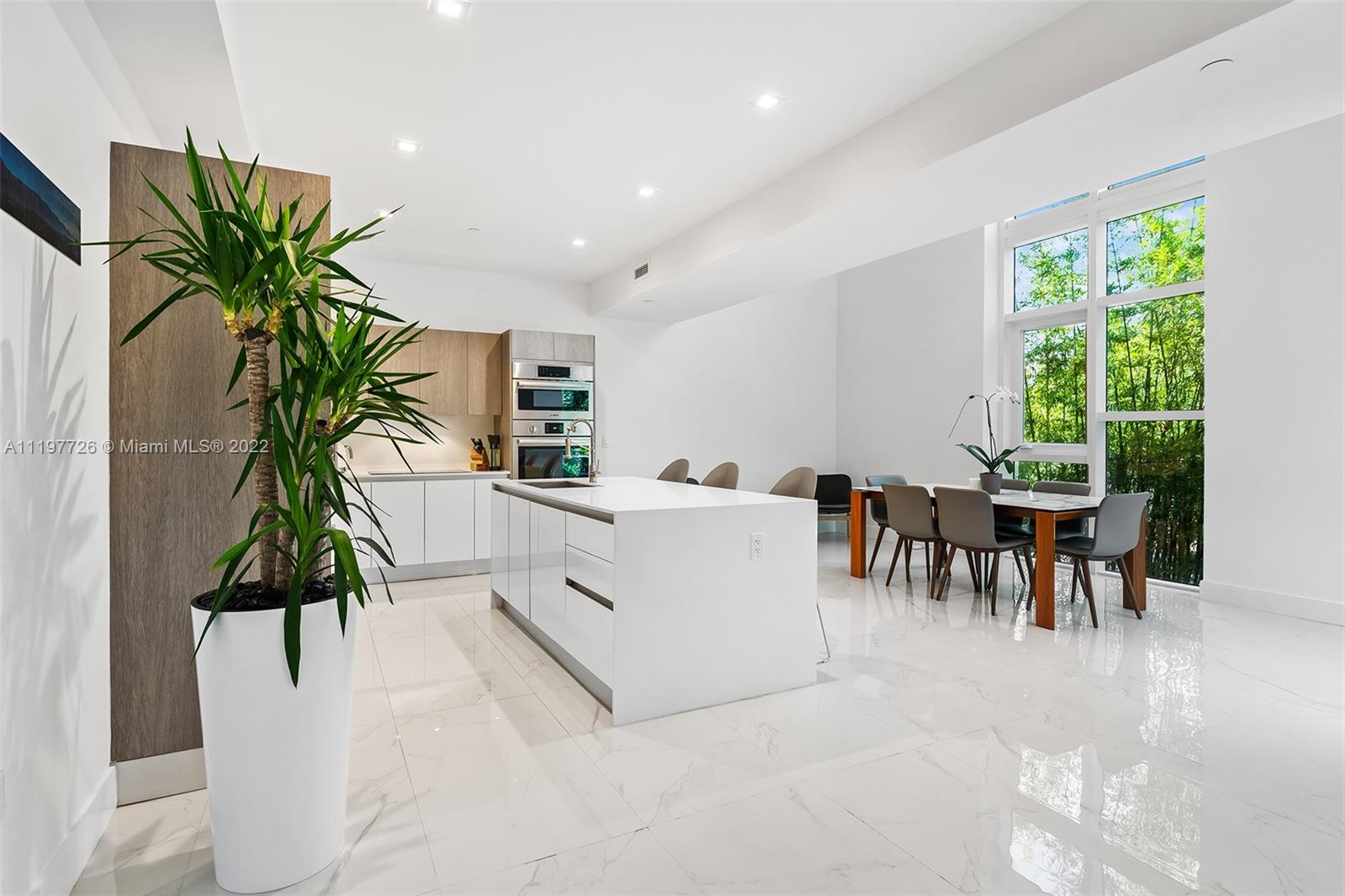 455 Northeast 39th Street, Unit 112 Miami, FL 33137 - Photo 4 of 40 a living room with furniture and a potted plant
