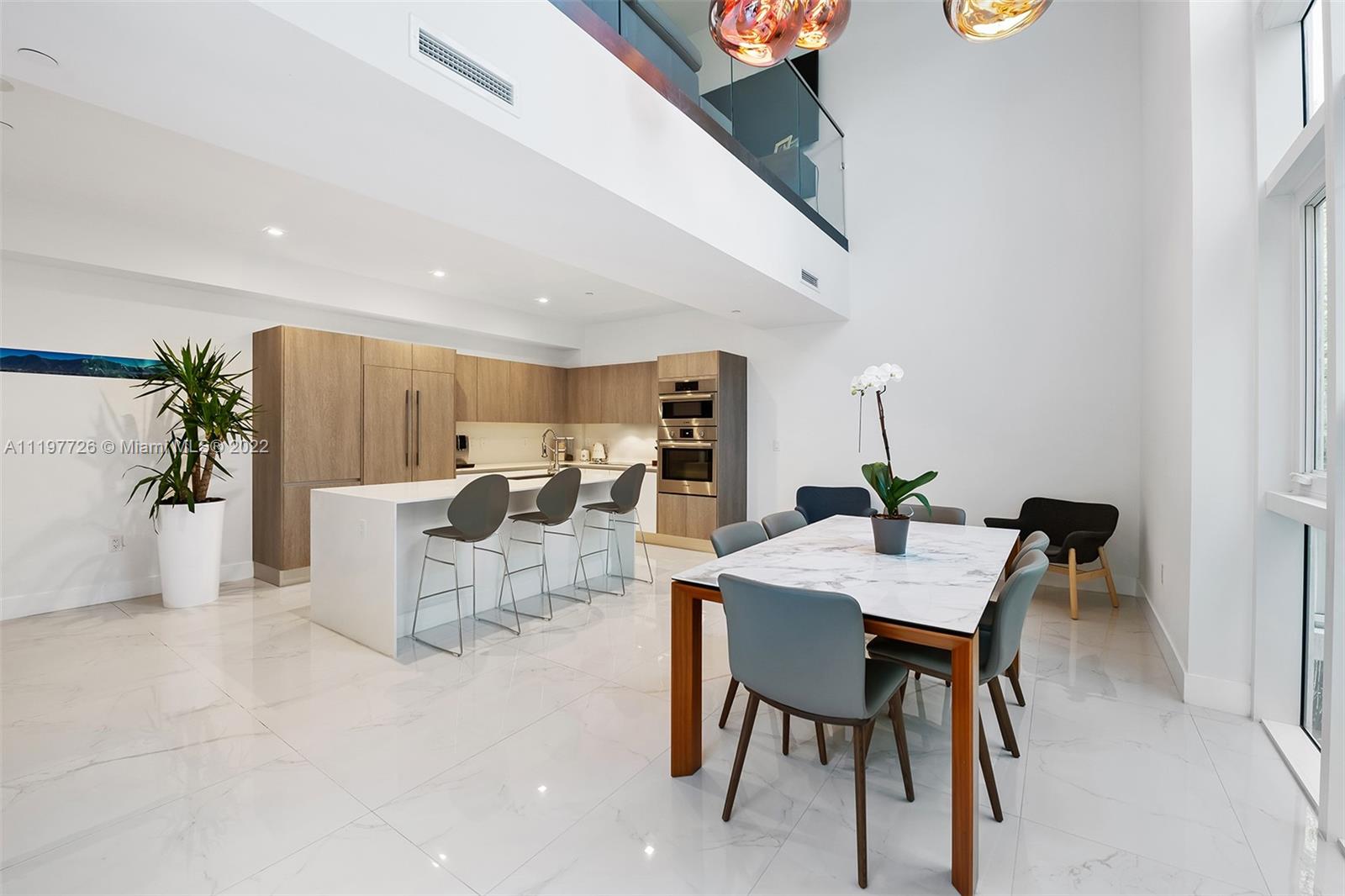 455 Northeast 39th Street, Unit 112 Miami, FL 33137 - Photo 9 of 40 a view of a dining room with furniture