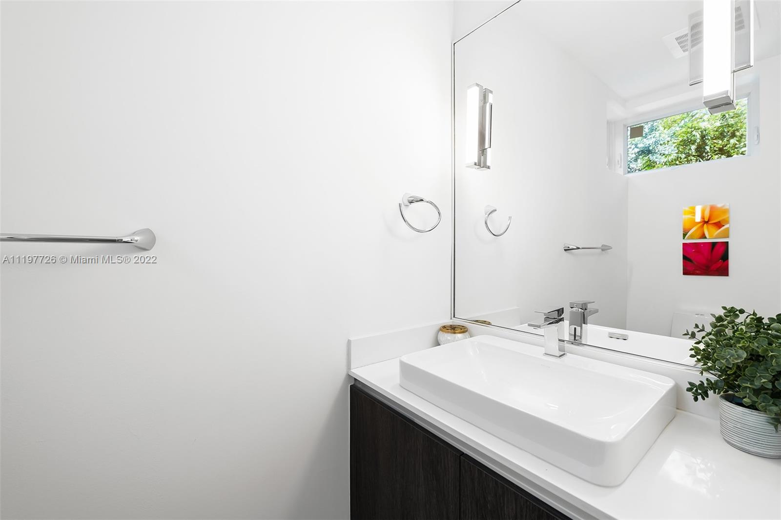 455 Northeast 39th Street, Unit 112 Miami, FL 33137 - Photo 10 of 40 a bathroom with a sink and a mirror