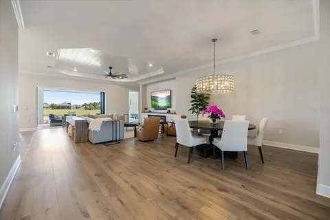 a living room with furniture and a chandelier
