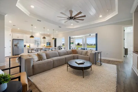 a living room with furniture a rug and a chandelier