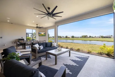 a living room with furniture and floor to ceiling window