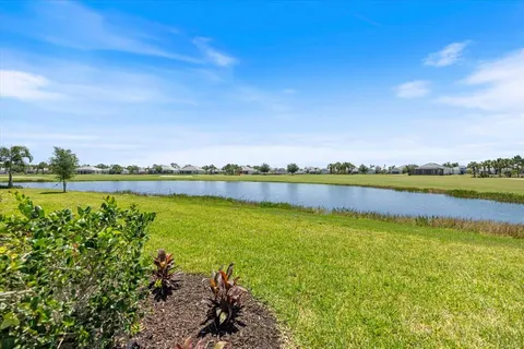 a view of a lake with houses in the back
