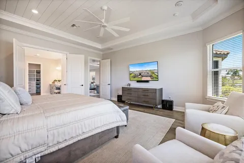 a spacious bedroom with a bed a couch and a window