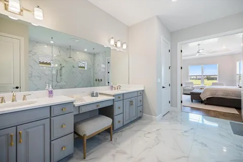 a spacious bathroom with a double vanity sink mirror and