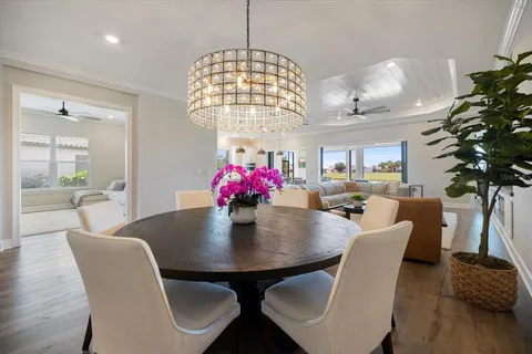 a view of a dining room with furniture wooden floor and chandelier