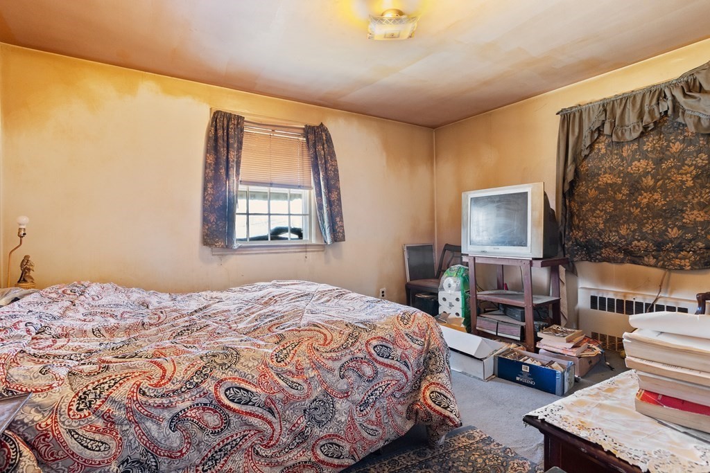 265 Varick Road Newton, MA 02468 - Photo 12 of 22 a bedroom with a bed and a flat screen tv
