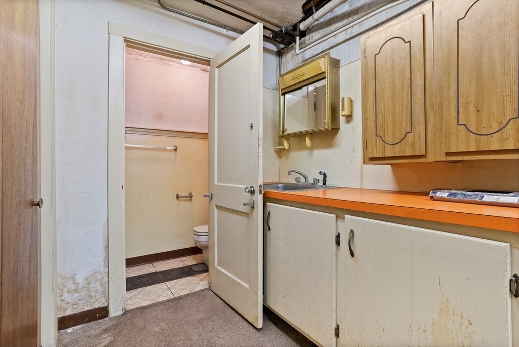 265 Varick Road Newton, MA 02468 - Photo 16 of 22 a bathroom with a sink and a mirror
