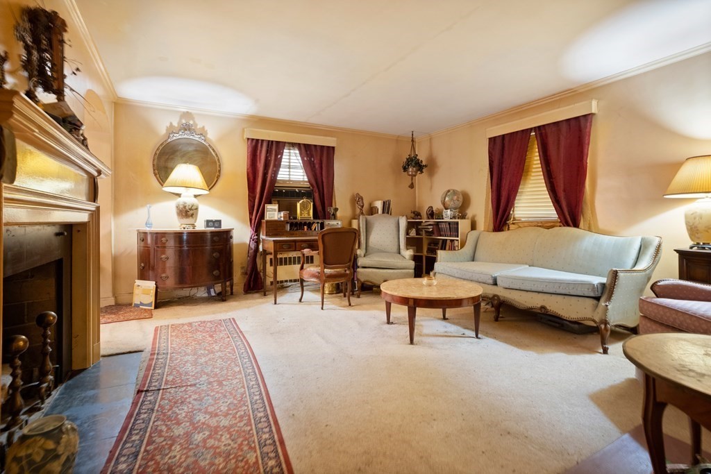 265 Varick Road Newton, MA 02468 - Photo 4 of 22 a living room with furniture and a fireplace