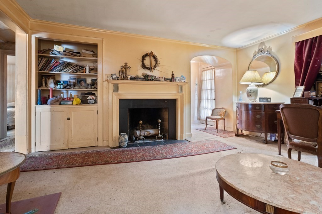 265 Varick Road Newton, MA 02468 - Photo 6 of 22 a living room with furniture and a fireplace