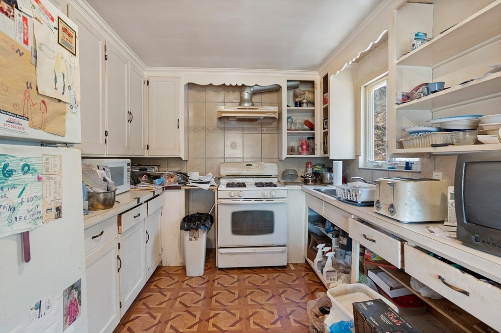 265 Varick Road Newton, MA 02468 - Photo 8 of 22 a kitchen with stainless steel appliances a sink and cabinets