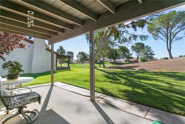 a view of a house with backyard porch and sitting area