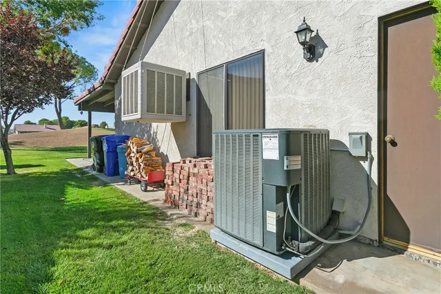a front view of a house with a garden and trees
